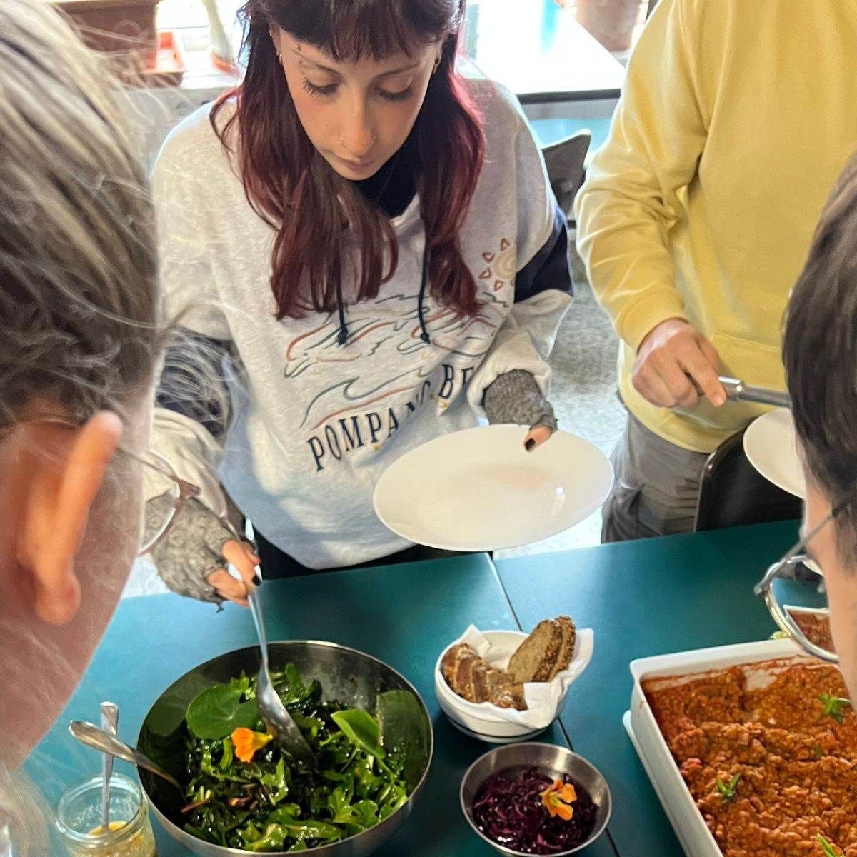 Person bedient sich am Buffet.